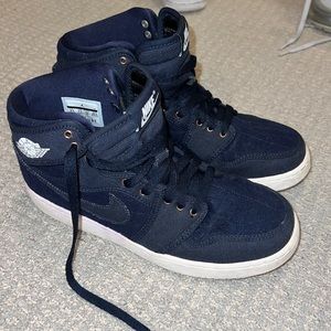Jordan 1. Navy blue quilted pattern with gold lace opening.